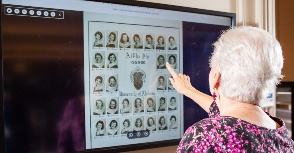 Image showing an Alpha Phi woman using the Onsite Digital Composite Interactive.
